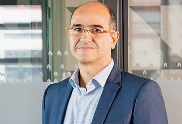 a person with a suit smiling