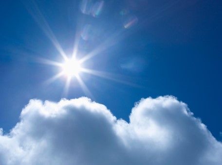 the sun shining through clouds