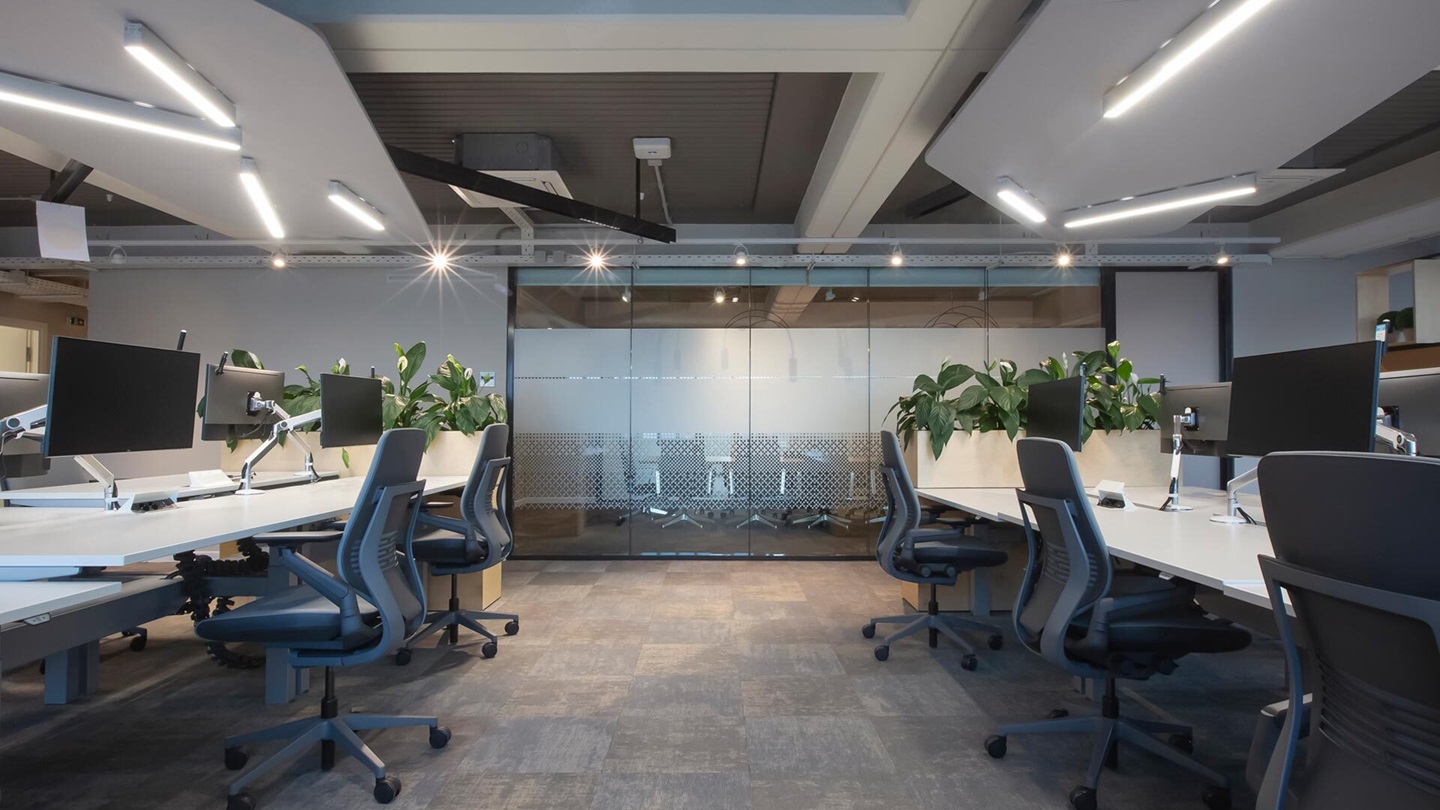 a room with chairs and computers