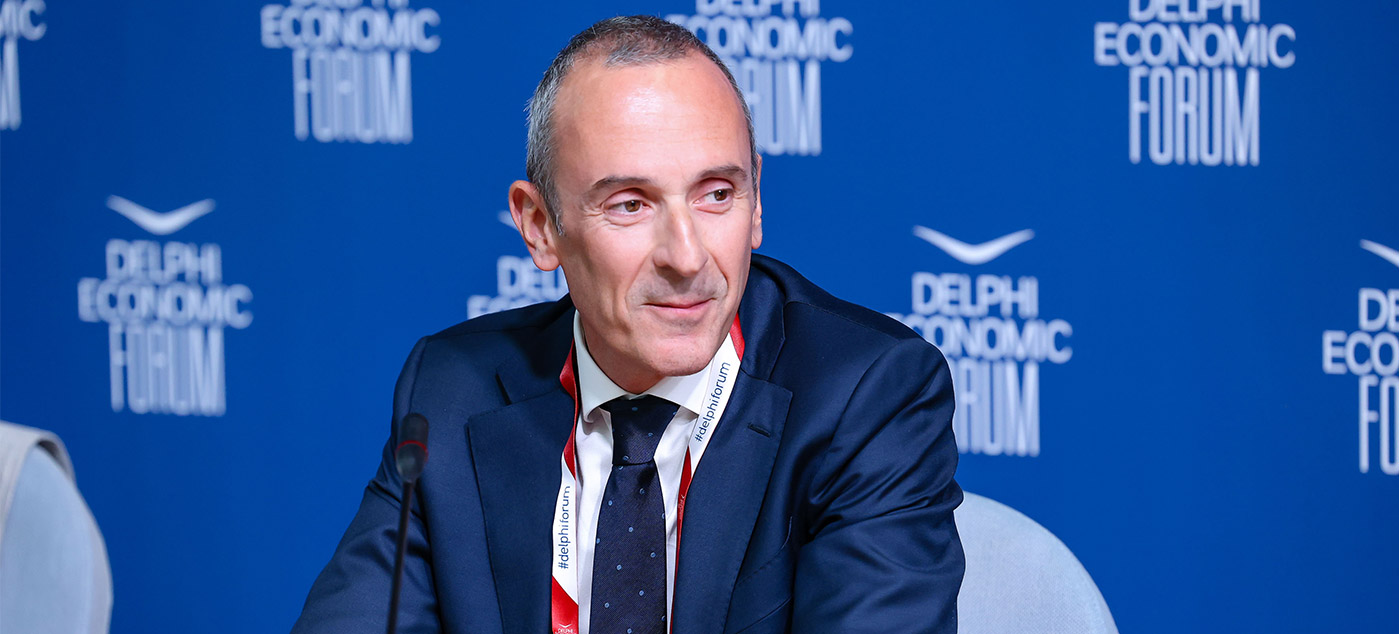 a person in a suit sitting at a table