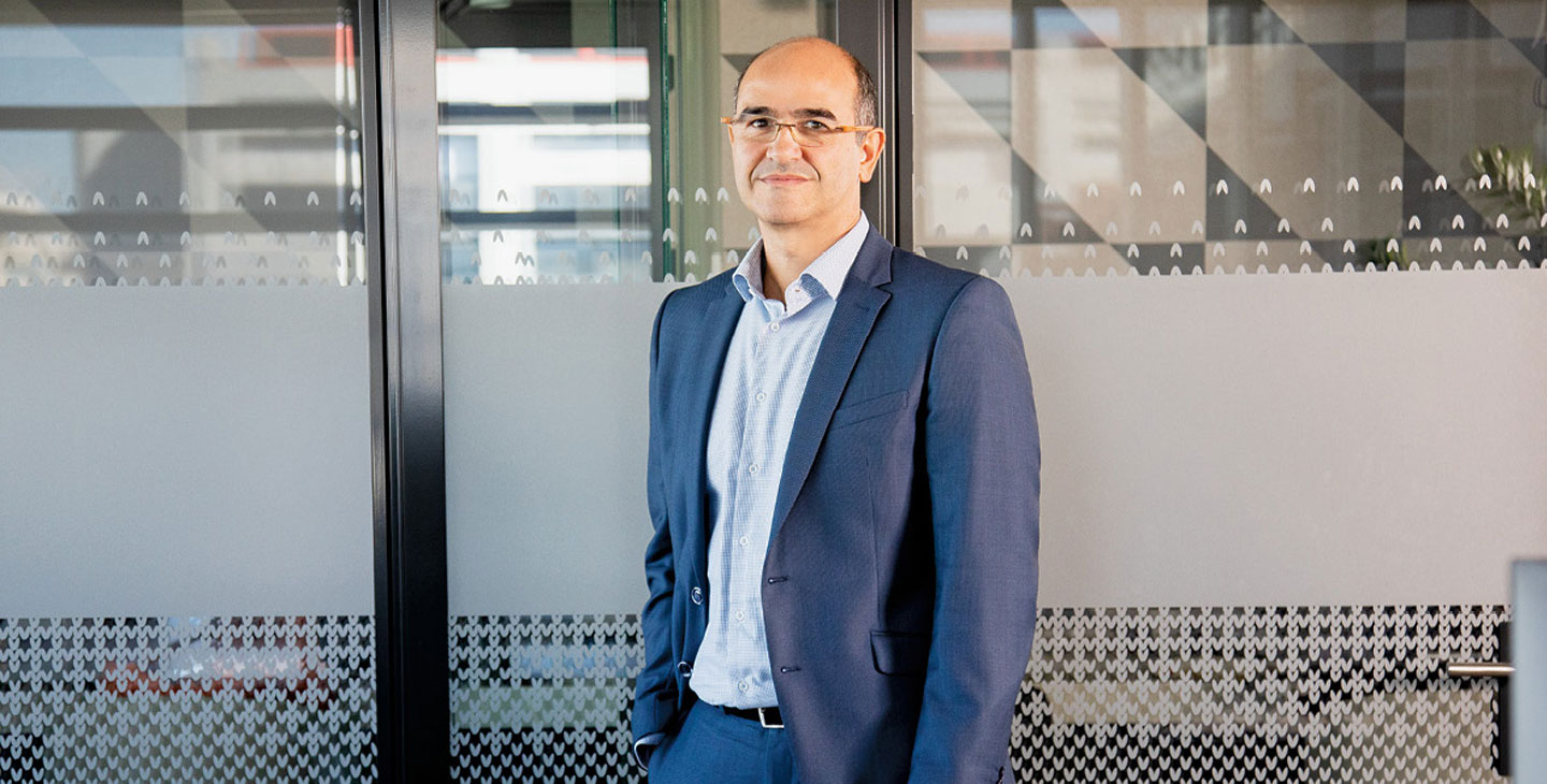 a person with a suit smiling