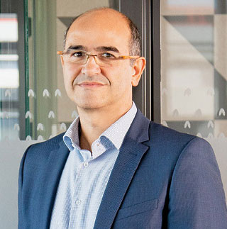 a person with a suit smiling